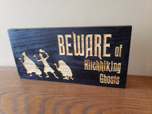 Beware of Hitchhiking Ghosts wood door sign