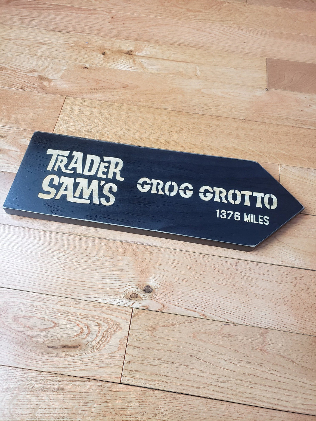 large Custom Directional sign with distance from your home to trader sam's grog grotto